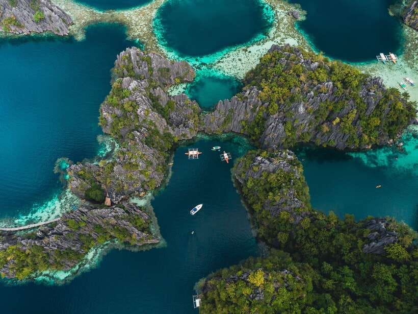 Coron: Private Island-Hopping Tour on a Yacht or Speedboat - Leaving Coron Harbor Square for a private day at sea