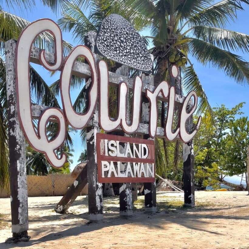 Puerto Princesa: Cowrie Island Guided Day Tour with Meal - Arriving by boat at a white-sand beach